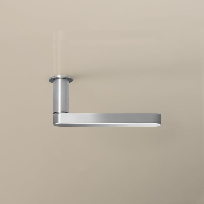 HEWI Range 270 PVD lever handle Nickel-effect door handle with a rectangular handle and a round rose on a beige-coloured wall