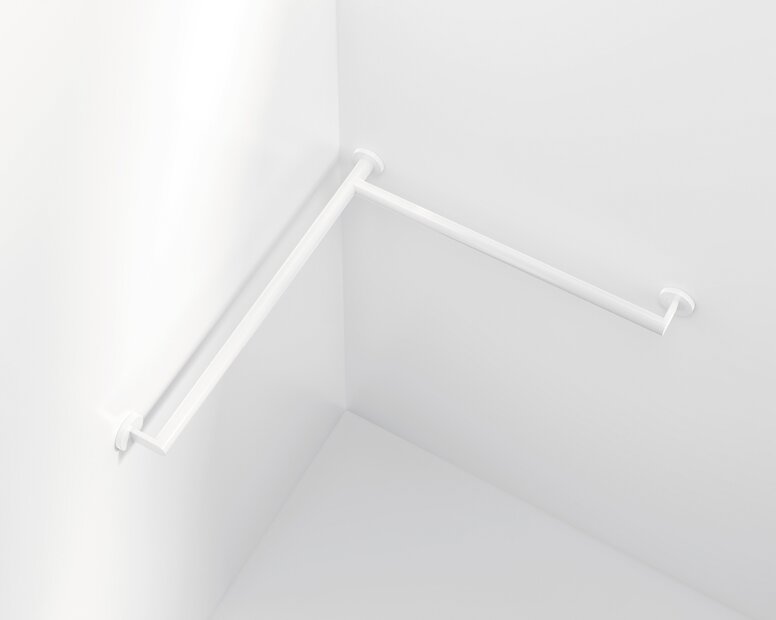 HEWI System 700 handrail White plastic handrail extending around a corner, with two long tubular sections and three round wall mounts against white walls