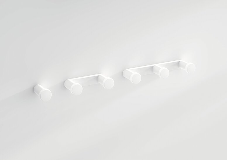 HEWI System 700 hooks White plastic wall hooks in three configurations: a single hook and strips with two and three hooks on a white wall