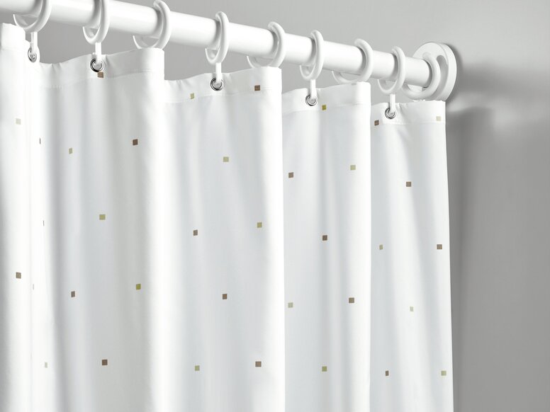 HEWI Range 801 curtain rail A shower curtain featuring small squares as a design detail, with white rings, hung on a white curtain rail against a light grey wall