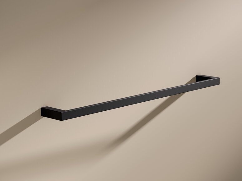 HEWI System 900Q Towel Holder Black powder-coated towel holder with a rectangular cross-section on a beige wall