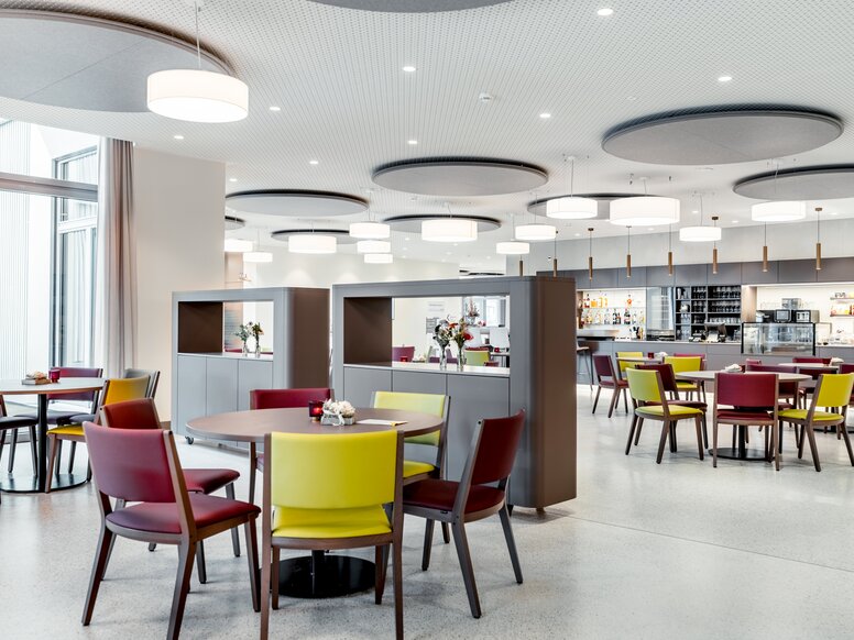 Bistro in Haslibrunnen, Switzerland Round tables with colourful chairs